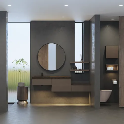 Stilrent og romslig baderomsinspirasjon med stort rundt speil med svart ramme, mørk steinvask, farget toalett, overskap og åpen hylle i et sofistikert og dempet design