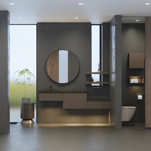 Stilrent og romslig baderomsinspirasjon med stort rundt speil med svart ramme, mørk steinvask, farget toalett, overskap og åpen hylle i et sofistikert og dempet design