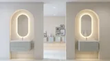 Stilfull og moderne baderomsinspirasjon med ovale speil med lysstyring, steinvasker og servantskap med fine og elegante riller i en minimalistisk design, badet har en lys og luftig atmosfære med elegant belysning og raffinerte detaljer